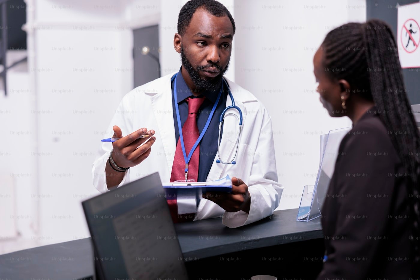 Healthcare professional speaking with a clinic team member