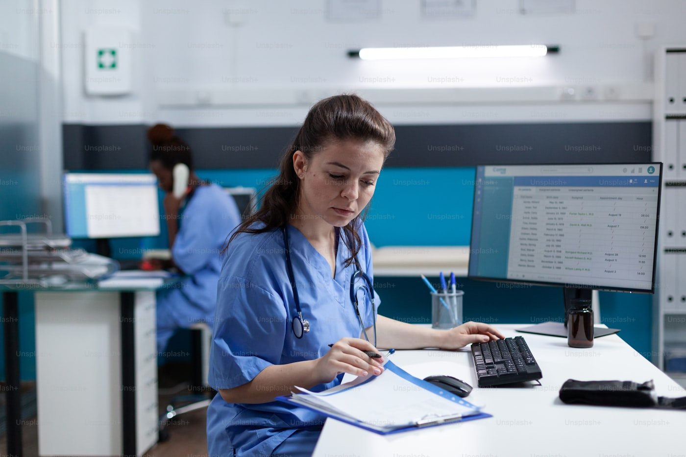 Healthcare professional reviewing notes at a desk
